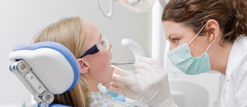 Dentist Checking Patient's Teeth